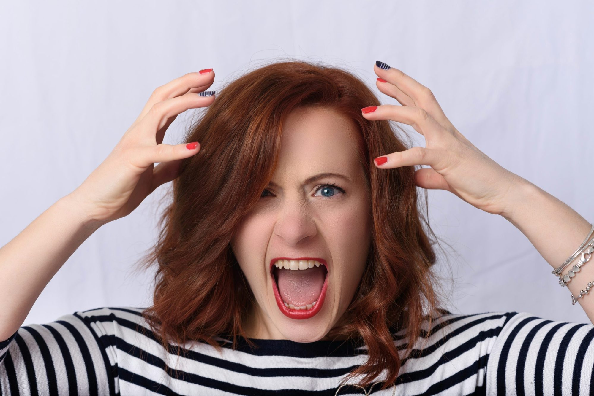 Frustrated woman in a stripy top screaming because ChatGPT isn't showing her website