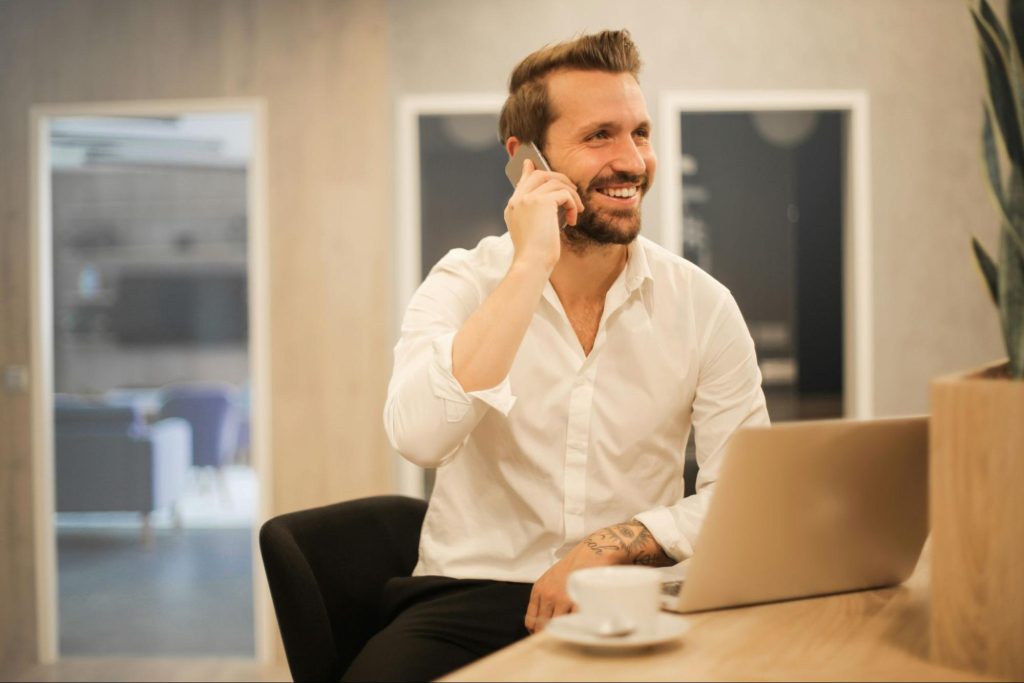 Man smiling talking on the phone about productive teams